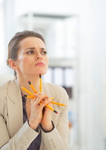 Business woman holding pencils